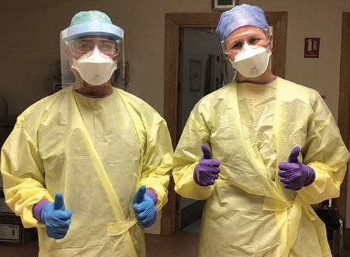 Medical professionals wearing full PPE Medical professionals wearing full PPE